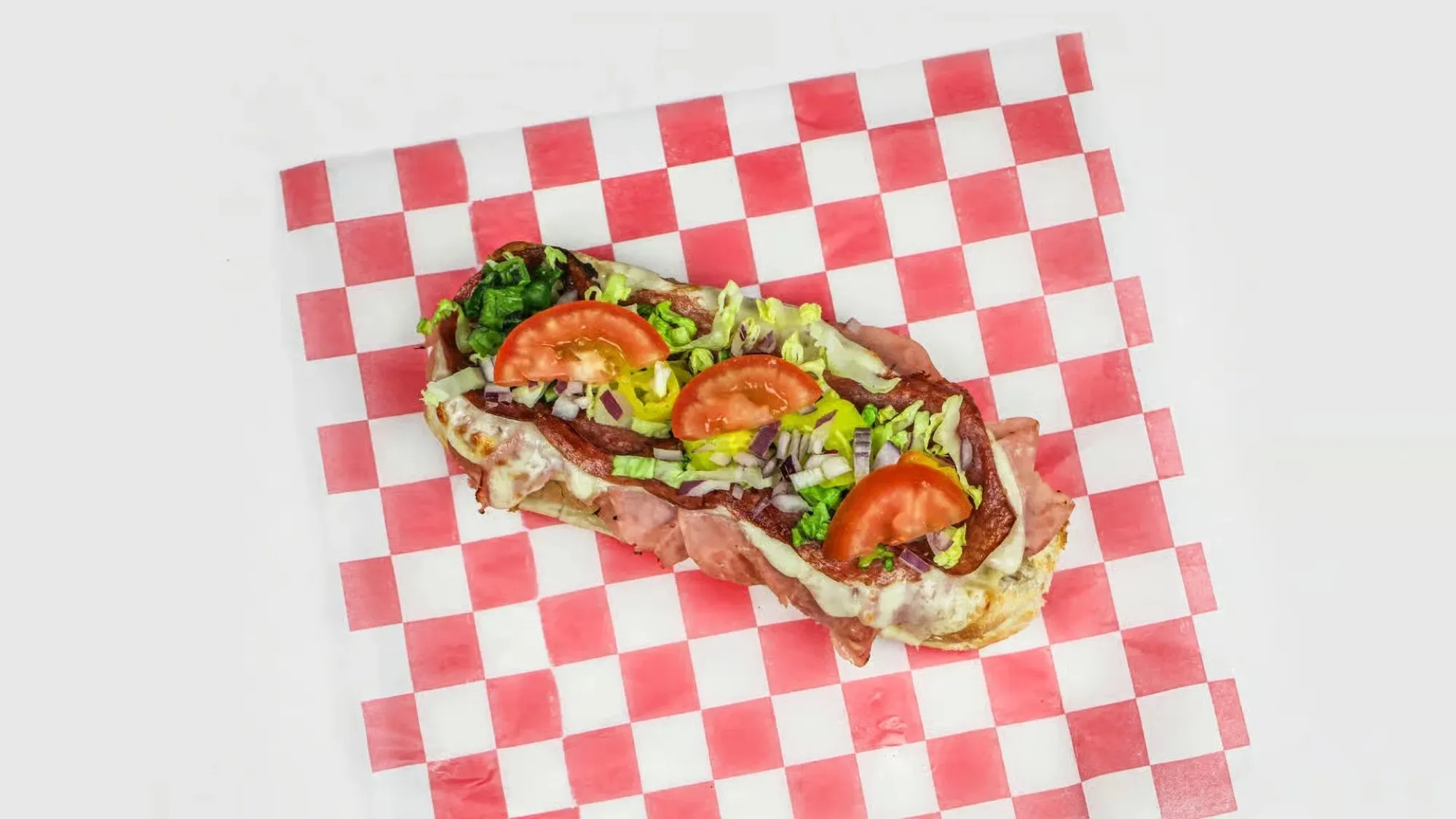 A Round Haus oven baked Italian sub with ham, salami, cheese, lettuce, tomato and peppers.